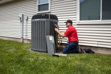 tech working on HVAC unit